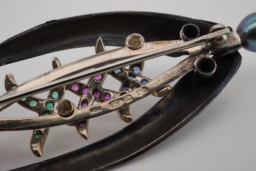 Rachel Jeffrey, a cultured pearl and gem-set brooch, 'The Pearl of the Dee', circa 2000,designed as a fly for fly fishing, set with circular-cut rubies, sapphires and emeralds, topped with a black cultured pearl, mounted